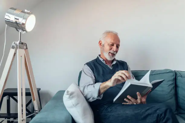 Elderly man reading a book