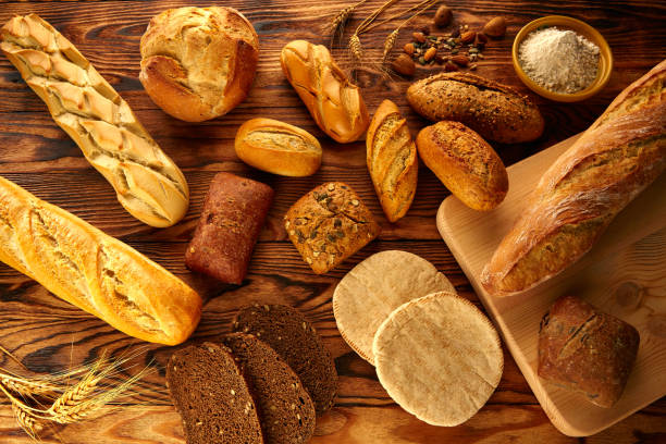 istock Bread varied mix on golden aged wood table 914941476