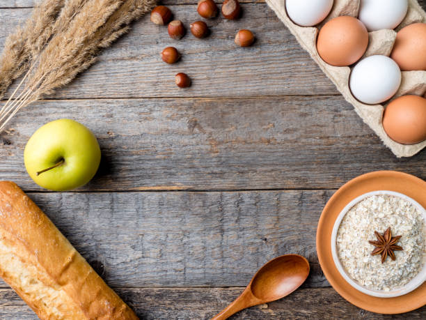 istock Ingredients for Breakfast Oatmeal Eggs Bread Apple Rustic Wooden background Copy space 914944408