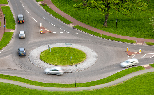 Motion blur as several cars use a roundabout.