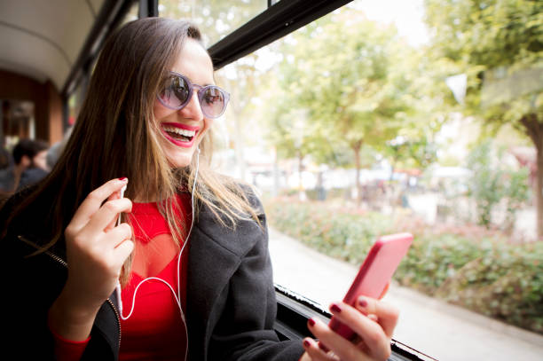 istock Young woman using smart phone on the tram 914945990