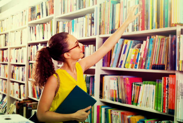 istock young woman in book shop 914949490