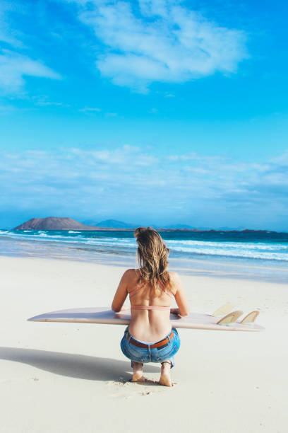 istock Surfer girl checking the waves 914949682