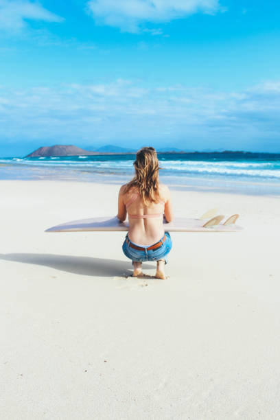 istock Surfer girl checking the waves 914952044