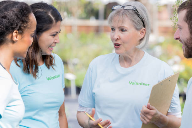 istock Volunteer coordinator instructs garden center volunteers 914953378