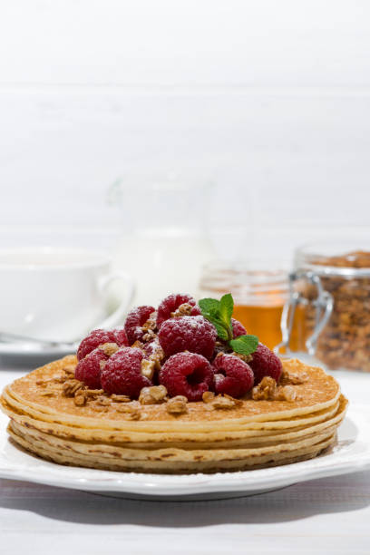 istock traditional pancakes with fresh raspberries for breakfast on wooden table 914953632