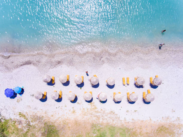 istock Sand beach in Greece aerial view with umbrellas and sun chairs 914953742