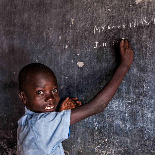 istock African young boy is learning English language, orphanage in Kenya 914954540