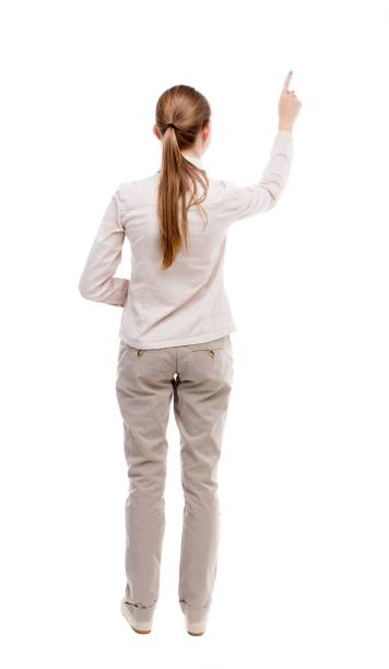 istock Back view of  pointing woman. 914960386