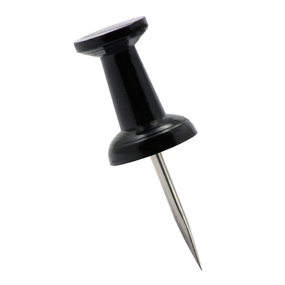 Black pushpin thumbtack drawing pin, isolated push fastening, position indicating concept, large detailed macro closeup