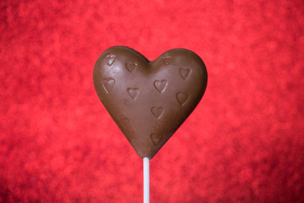 istock Sweet chocolate hearts on red background 914961344