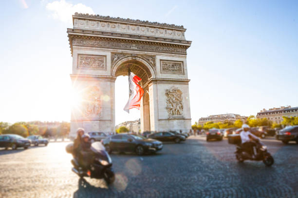 istock Arc de Triomphe in Paris with a big French flag under it 914965496
