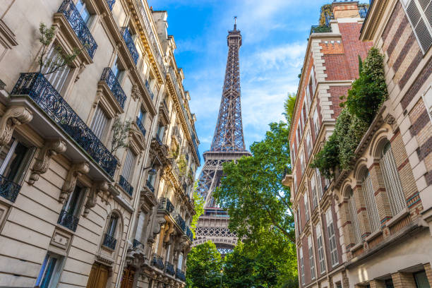 istock Eiffel tower in central Paris between residential old architecture buildings 914965670