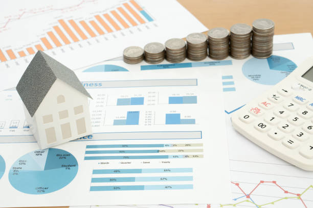 istock With House Model And Stack Of Coins On Desk 914966606