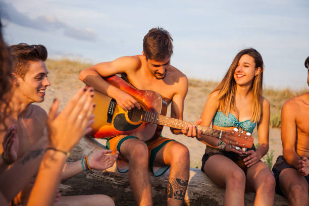 istock Group of friends on the beach during a vacation 914968520