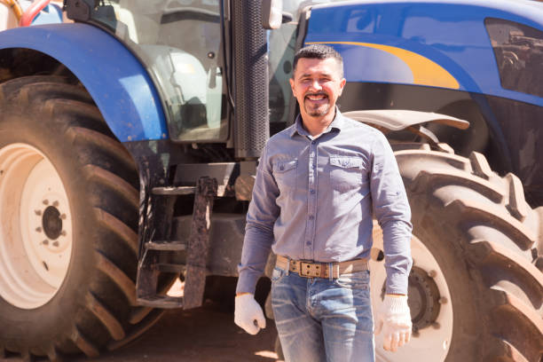 istock Mature farmer near tractor 914969542