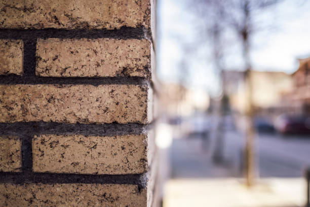 istock Brick wall rock corner wall on a blurred street 914969628