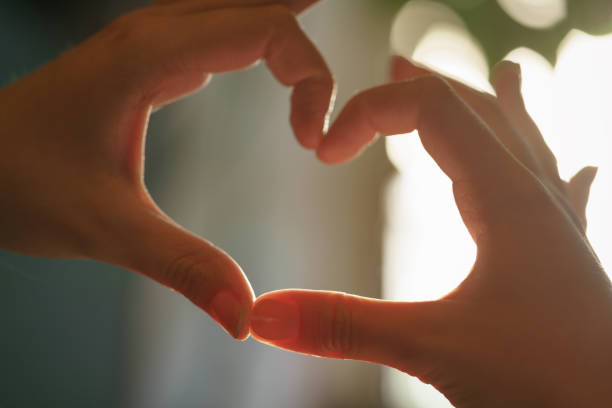 istock teen girl making heart shape with hands 914970280