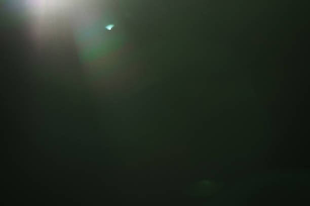istock real green lens flare over dark background 914970350