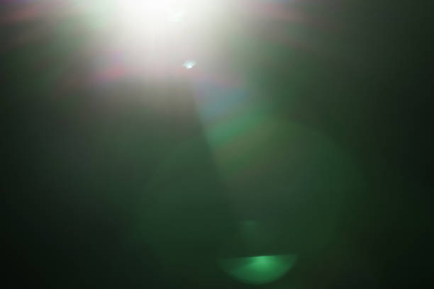 istock real green lens flare over dark background 914970368