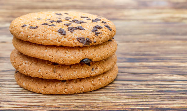 istock Stack of cookies with chocolate on wooden table. 914978058