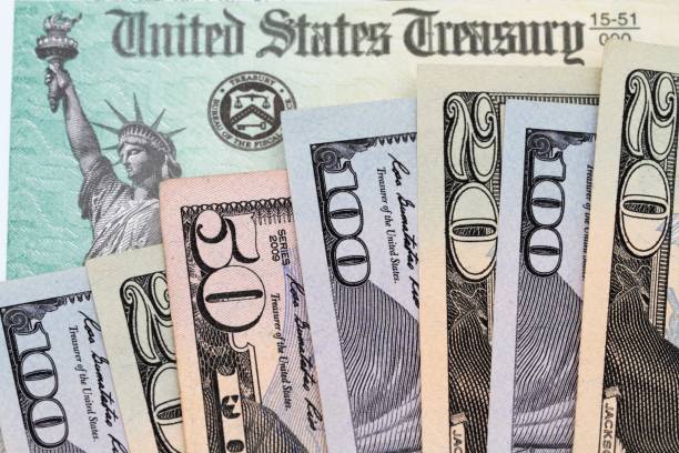 istock USA currency 20, 50 and 100 bills on Treasury check 914979708