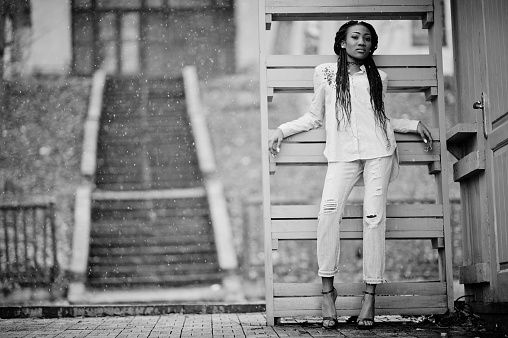 Stylish african american girl with dreads outdoor.