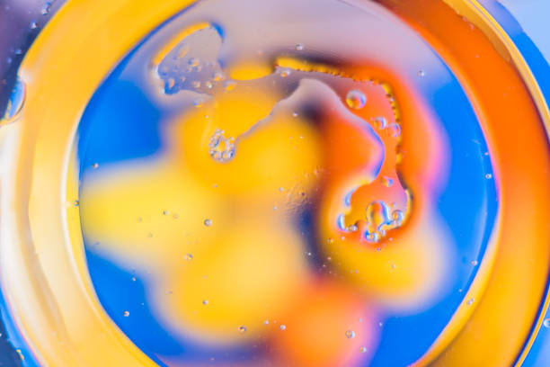 istock Oil on water - abstract macro background. 914989482