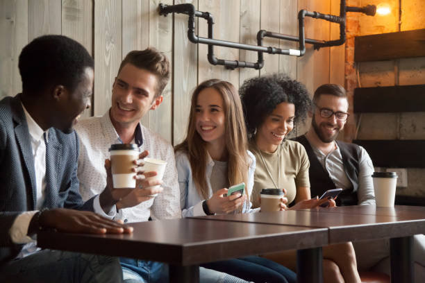 istock Happy multi-ethnic group of friends talking using smartphones at meeting 914989782