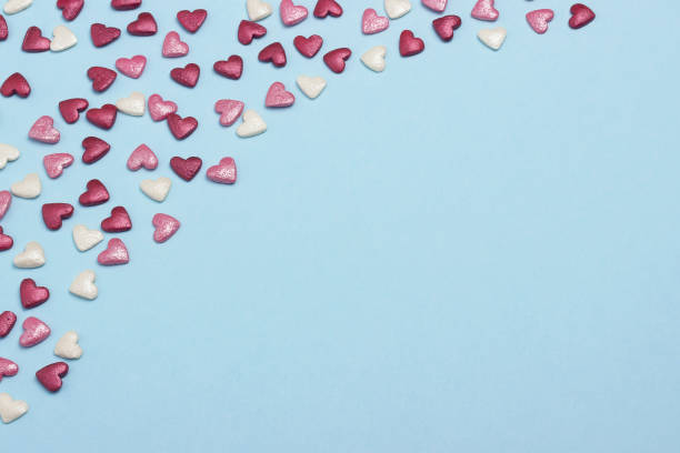 istock Blue, red and pink hearts on blue cardboard background. 914990262
