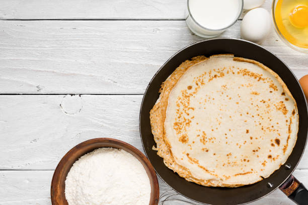 istock Stack of pancakes on frying pan with ingredients 914991986