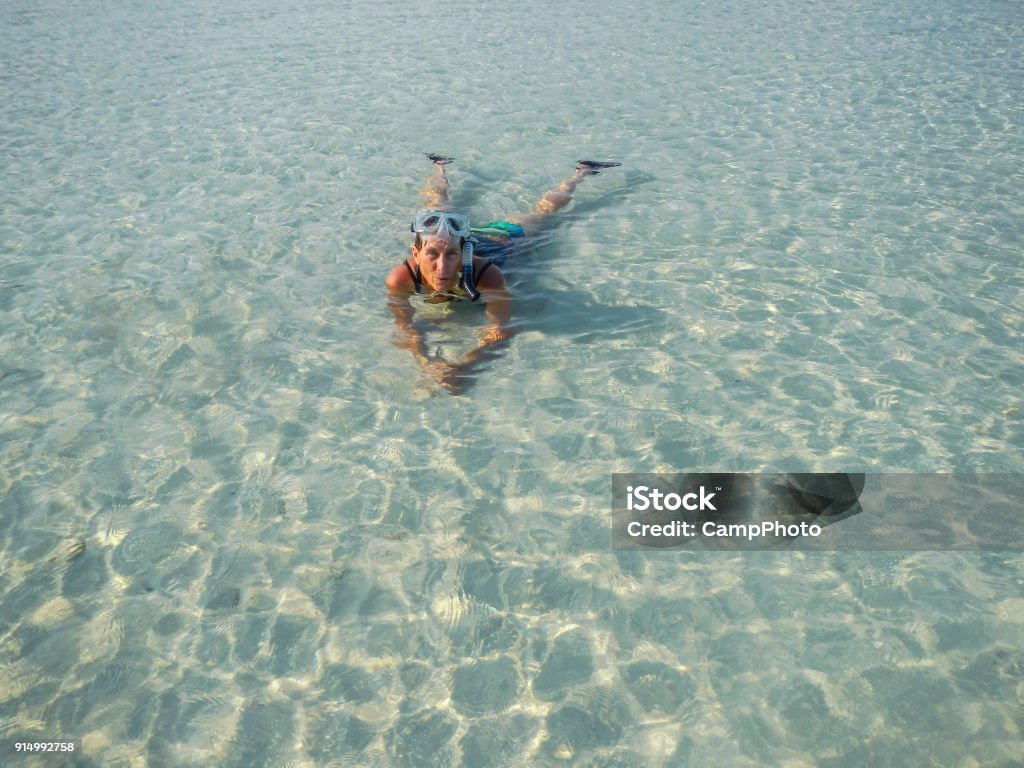 Tropical water bliss Woman lying in warm water in the Andaman Sea. Thailand, Southeast Asia. 50-59 Years Stock Photo