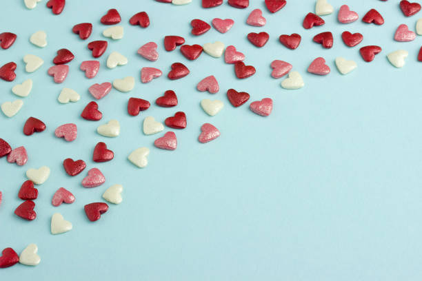 istock Blue, red and pink hearts on blue cardboard background. 914994500