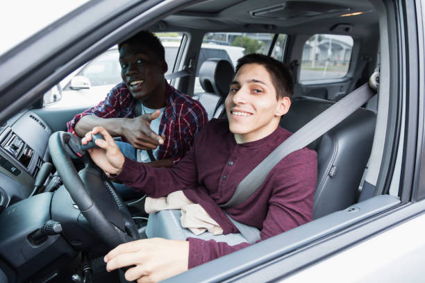 istock Amputee driving specially equipped car, with friend 914995230