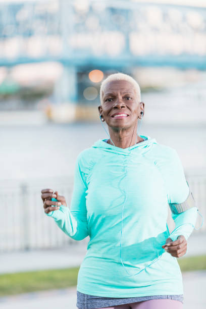 istock Senior African-American woman running on waterfront 914997888