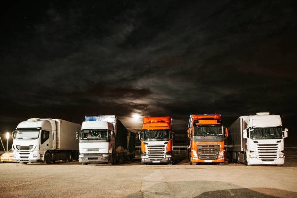 istock Trucks in a parking lot at night 915001330