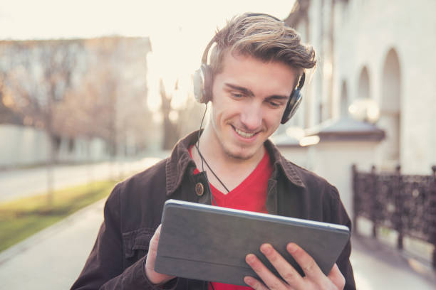 handsome man using tablet outside - hipster people surfing the net internet imagens e fotografias de stock