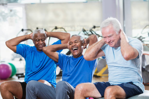 istock Three multi-ethnic senior men in gym exercising 915005224