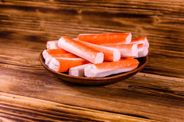 istock Ceramic plate with crab sticks on wooden table 915005788