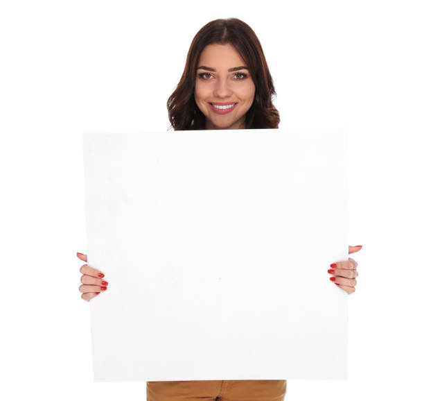 istock smiling woman holding and showing a blank board 915008456