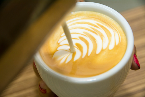 Making latte art by barista