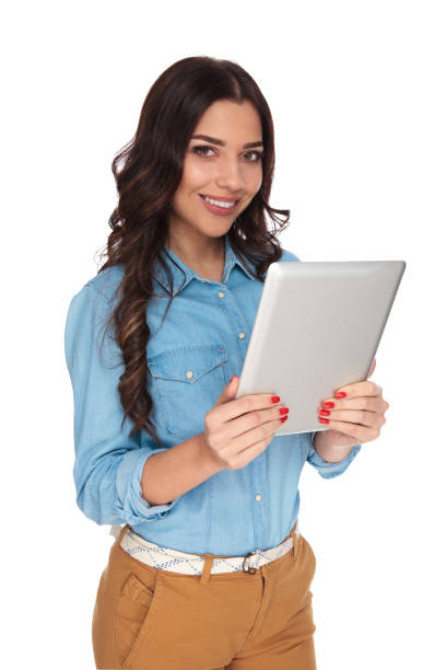 istock smiling casual woman reading on tablet 915008618
