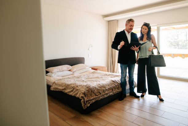istock Real Estate Agent showing the contract papers to client 915013020