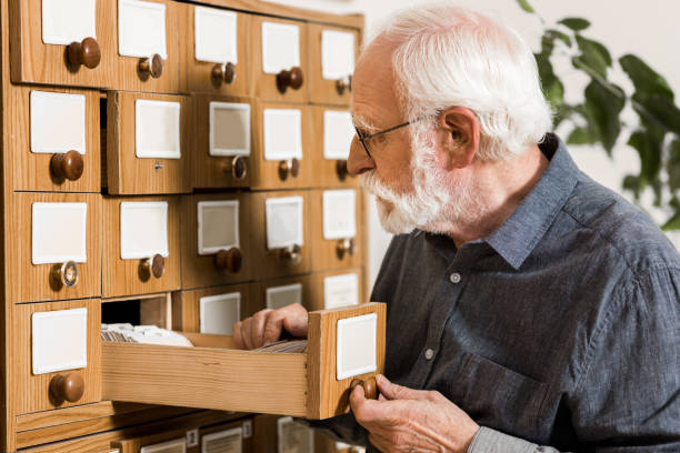 istock senior male archivist searching for catalogs 915017428