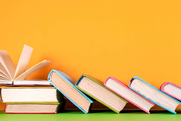 istock Open book, hardback books on bright colorful background. 915018228
