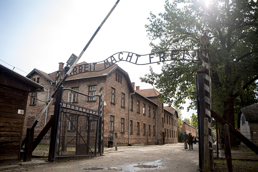 Auschwitz, Poland - August 28, 2017: Arbeit macht frei (work sets you free) slogan on the entrance of Auschwitz concentration camp, the biggest extermination camp in Europe built by Nazi.