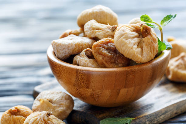 istock Wooden bowl with dried figs. 915018456