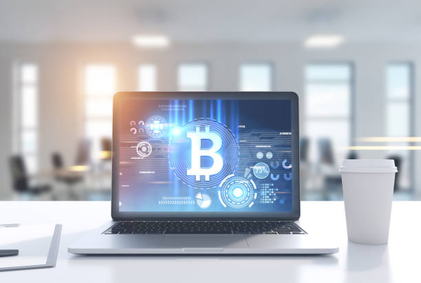 istock Laptop with a bitcoin symbol in office, coffee cup 915018626