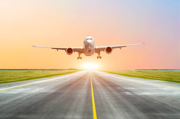 istock Large passenger plane take off from the runway before the light from the sunshine. 915018844