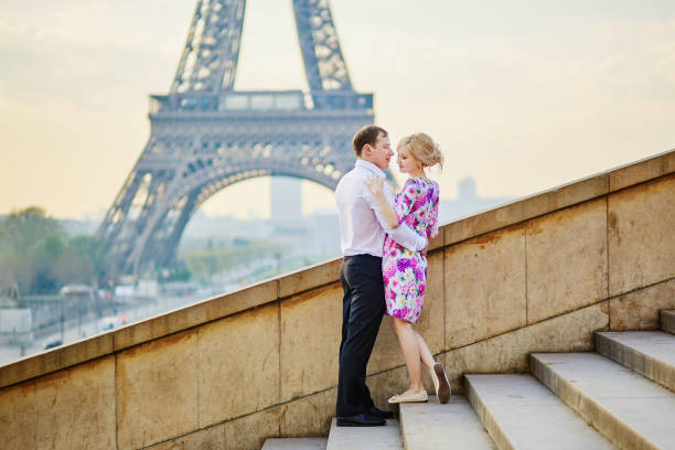 paar vor dem eiffelturm in paris, frankreich - paris france eiffel tower love kissing stock-fotos und bilder